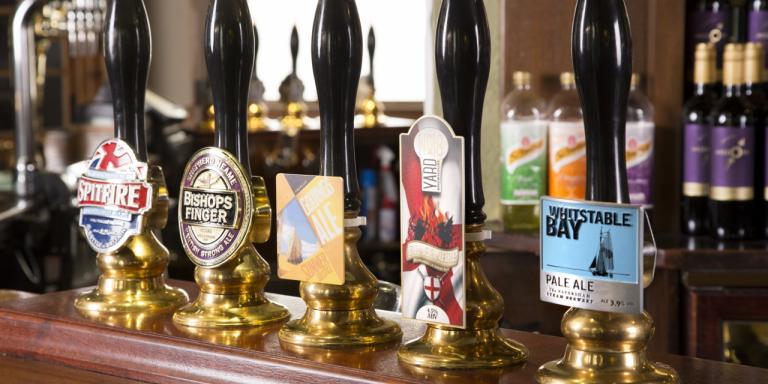 An image of mixed pump clips from Shepherd Neame on the bar.